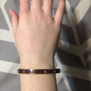 Coach bangle bracelet maroon and gold colored. Measures 7 inches circumference.